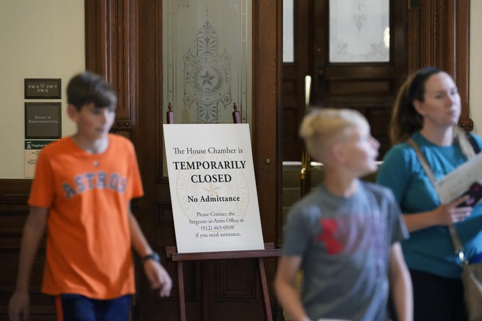 Visitors walk past the "Temporarily Closed" doors to the House Chamber at the State Capitol, Tuesday, June 1, 2021, in Austin, Texas. The Texas Legislature closed out its regular session Monday, but are expected to return for a special session after Texas Democrats blocked one of the nation's most restrictive new voting laws with a walkout. (AP Photo/Eric Gay)