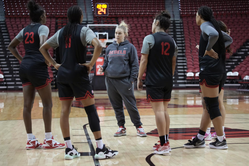 UNLV women's NCAA college basketball head coach Lindy La Rocque, center, speaks with players during practice Wednesday, Feb. 15, 2023, in Las Vegas. La Rocque is in her third season at UNLV, and she keeps taking the program up a step each year.(AP Photo/John Locher)