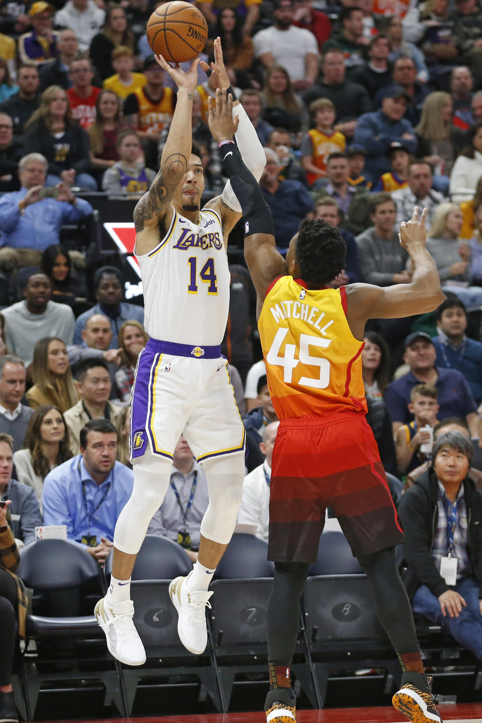 Los Angeles Lakers guard Danny Green (14) shoots as Utah Jazz guard Donovan Mitchell (45) defends in the first half during an NBA basketball game Wednesday, Dec. 4, 2019, in Salt Lake City. (AP Photo/Rick Bowmer)