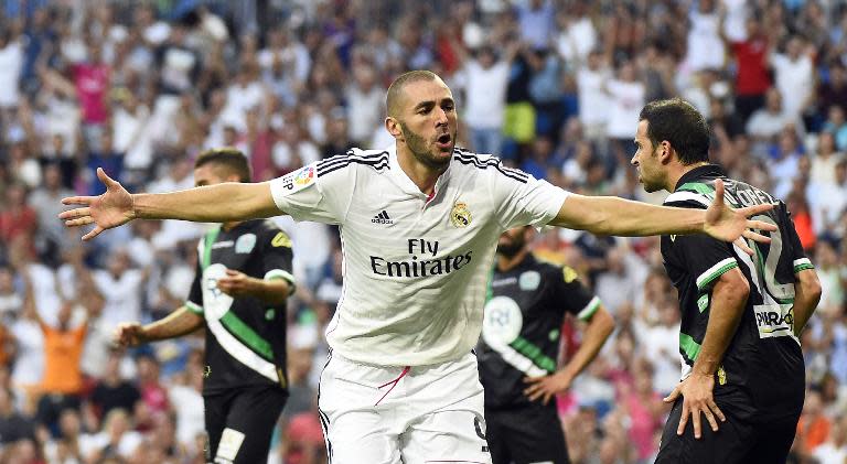 Real Madrid's Karim Benzema celebrates after scoring during the Spanish league match against Cordoba at the Santiago Bernabeu stadium in Madrid, on August 25, 2014