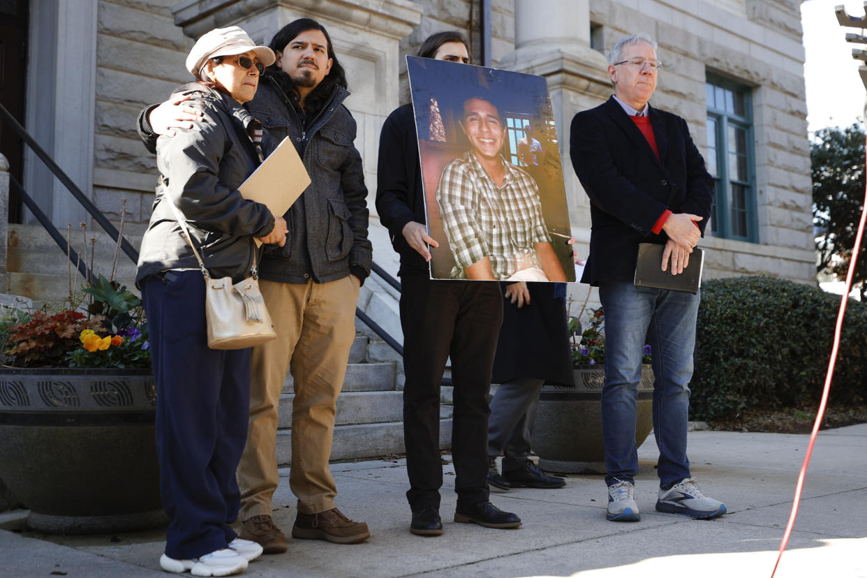 Belkis Terán, left, Daniel Paez, second left, Pedro Terán, second right, and Joel Paez, right, family members of Manuel Esteban Paez Terán, stand during a press conference, Monday, March 13, 2023, in Decatur, Ga. A press conference was held to give additional autopsy findings in Terán's death. (AP Photo/Alex Slitz)