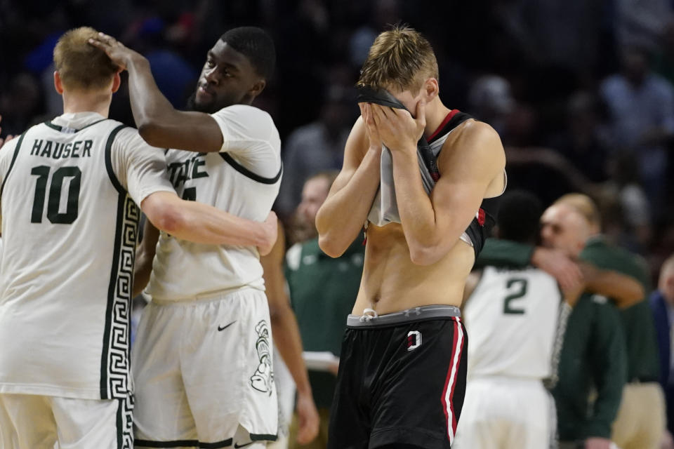 Davidson guard Grant Huffman reacts to their loss against Michigan State during a college basketball game in the first round of the NCAA tournament on Saturday, March 19, 2022, in Greenville, S.C. (AP Photo/Chris Carlson)