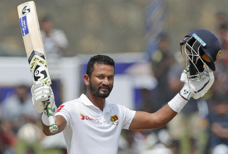 Sri Lankan's Dimuth Karunaratne celebrates scoring a century during the day five of the first test cricket match between Sri Lanka and New Zealand in Galle, Sri Lanka, Sunday, Aug. 18, 2019. (AP Photo/Eranga Jayawardena)