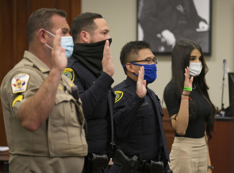 Witnesses are addressed by the judge during a bond revocation hearing on a murder charge for Victor Hugo Cuevas, a 26-year-old who has been recently linked to a missing tiger named India, at Fort Bend County Justice Center on Friday, May 14, 2021, in Richmond, Texas. Prosecutors in Fort Bend County are seeking to revoke a bond for Victor Hugo Cuevas after he was charged with murder in a 2017 fatal shooting. (Godofredo A. Vásquez/Houston Chronicle via AP)