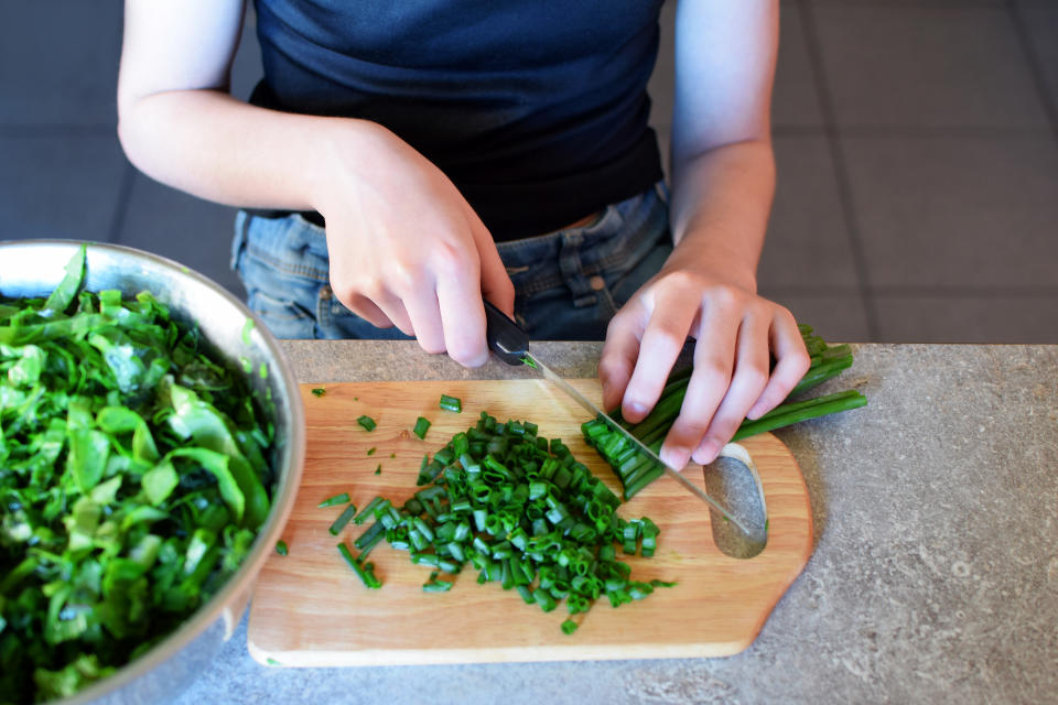 It's important to practice a few essential cooking skills with your kids at home before they leave for college. (Photo: Getty Creative)