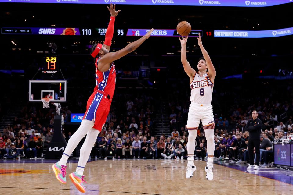 Grayson Allen #8 of the Phoenix Suns shoots from the three-point line against Ricky Council IV #16 of the Philadelphia 76ers during the second half at Footprint Center on March 20, 2024 in Phoenix.