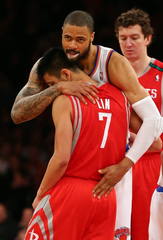 Tyson Chandler of the New York Knicks embraces former teammate Jeremy Lin of the Houston Rockets before the opening tipoff on December 17, 2012 at Madison Square Garden in New York City. Lin is one of the few Asian Americans in NBA history, and the first American of Taiwanese descent to play in the league