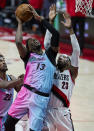 Miami Heat center Bam Adebayo, left, shoots over Portland Trail Blazers forward Robert Covington during the first half of an NBA basketball game in Portland, Ore., Sunday, April 11, 2021. (AP Photo/Craig Mitchelldyer)