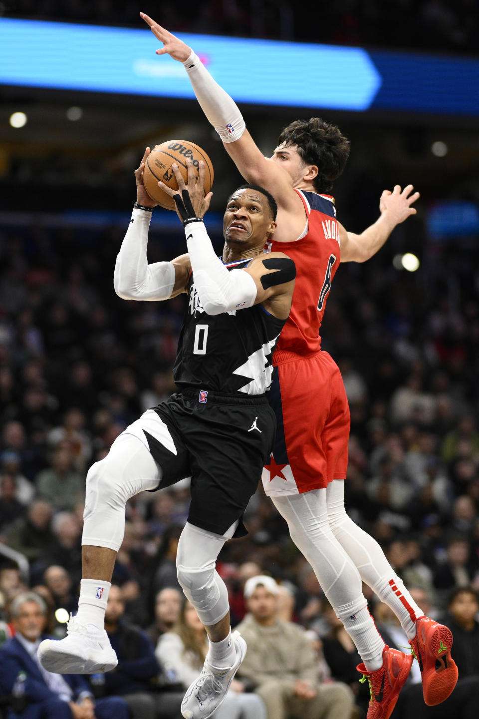 Los Angeles Clippers guard Russell Westbrook (0) goes to the basket against Washington Wizards forward Deni Avdija (8) during the first half of an NBA basketball game, Wednesday, Jan. 31, 2024, in Washington. (AP Photo/Nick Wass)