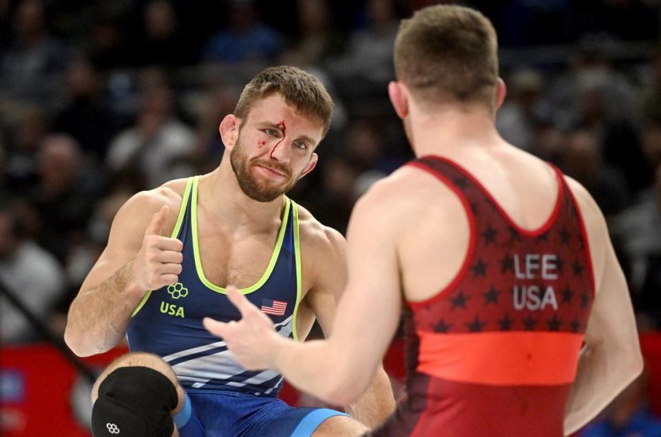 Zain Retherford motions to Nick Lee as they both have blood during their first bout of the 65 kg challenge round U.S. Olympic Team Trials at the Bryce Jordan Center on Saturday, April 20, 2024.