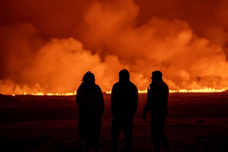 <p>AP Photo/Marco Di Marco</p> People watch the volcanic eruption near Grindavik, Iceland