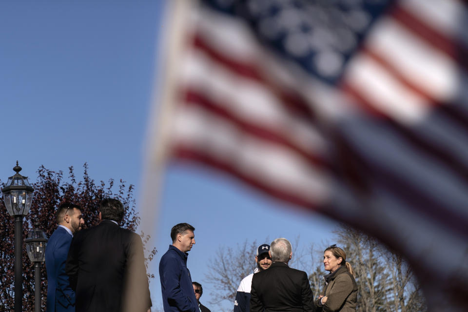 Rhode Island General Treasurer and Democratic candidate for the state's 2nd Congressional District, Seth Magaziner, center, talks with voters and fellow Democratic politicians outside a polling site in Johnston, R.I., Tuesday, Nov. 8, 2022. (AP Photo/David Goldman)