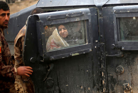 An Iraqi woman, who was wounded during clashes in the Islamic State stronghold of Mosul, is brought into a field hospital in al-Samah neighborhood, Iraq. REUTERS/Mohammed Salem