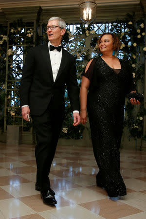 FILE PHOTO: Chief Executive Officer (CEO) of Apple Tim Cook and Lisa Jackson arrive for the State Dinner in honor of French President Emmanuel Macron at the White House in Washington, U.S., April 24, 2018. REUTERS/Joshua Roberts/File photo