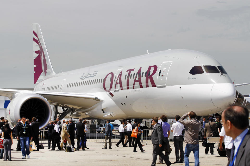 Visitors walk near a Qatar Airways Boeing 787 Dreamliner, on the first day of the Paris Air Show at Le Bourget airport, north of Paris, Monday June 17, 2013. (AP Photo/Remy de la Mauviniere)