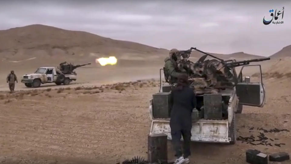 This image made from militant video posted online by the Aamaq News Agency, a media arm of the Islamic State group on Saturday, Dec. 10, 2016, purports to show gun-mounted vehicles operated by the group firing at Syrian troops in the Hayan mountain south of Palmyra, in Homs province, Syria. Syrian opposition activists say the Islamic State group has regained control of the ancient town of Palmyra despite a wave of Russian airstrikes in a major advance after a year of setbacks for the group in Syria and Iraq. (Militant Video via AP)