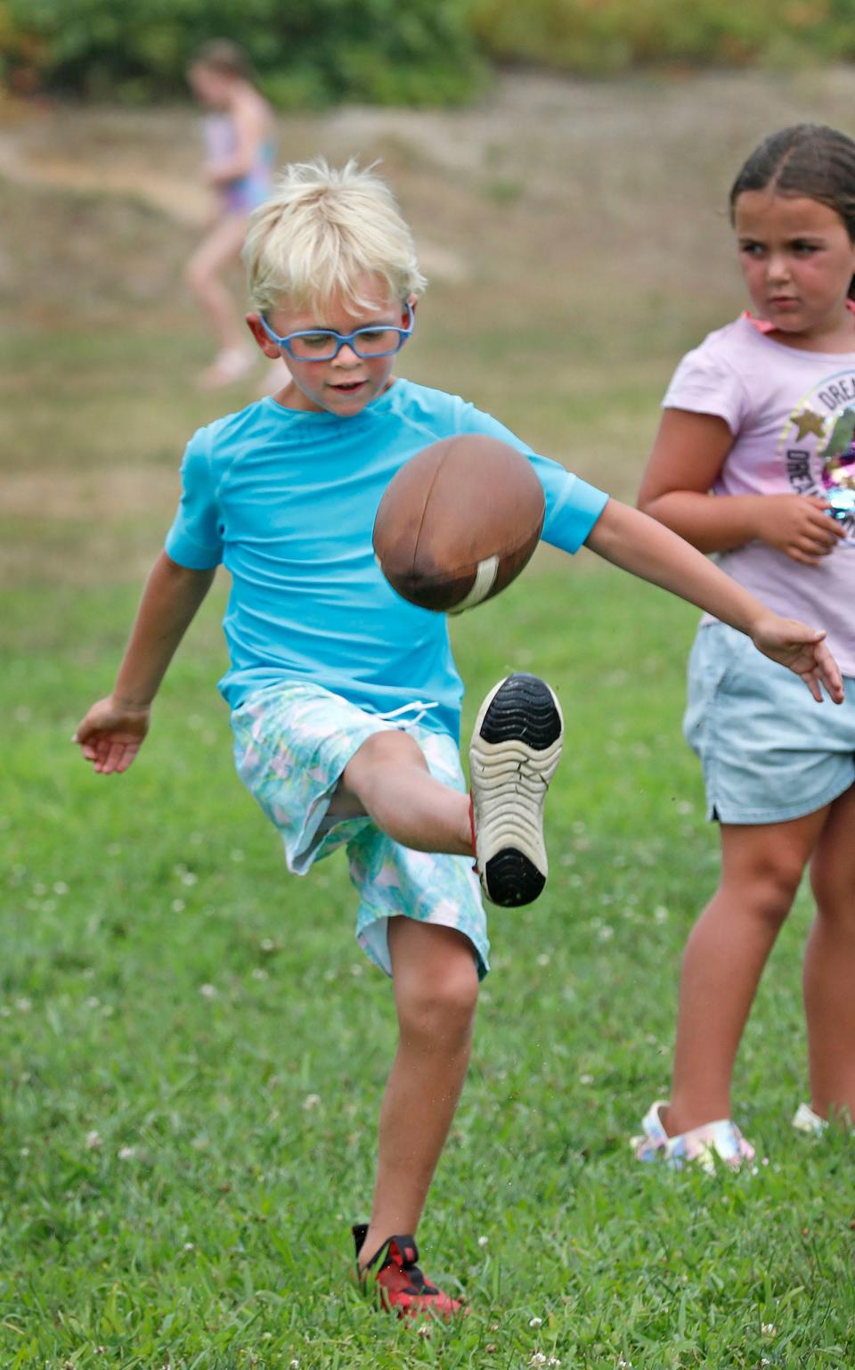 Sam Stevens, 6,  practices his punting at the Marshfield Boys and Girls Club Friday, Aug. 5, 2022.