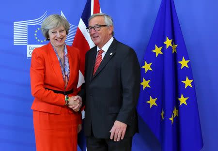 British Prime Minister Theresa May (L) is welcomed by European Commission President Jean-Claude Juncker at the EC headquarters in Brussels, Belgium October 21, 2016. REUTERS/Yves Herman