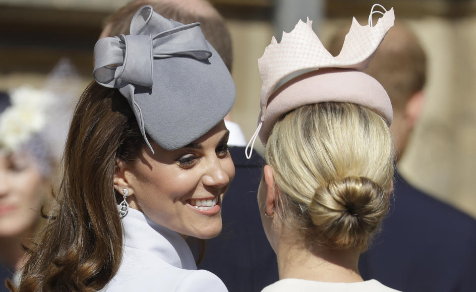 Britain's Kate, The Duchess of Cambridge, left, smiles with Zara Tindall as they arrive to attend the Easter Mattins Service at St. George's Chapel, at Windsor Castle in England Sunday, April 21, 2019. (AP Photo/Kirsty Wigglesworth, pool)