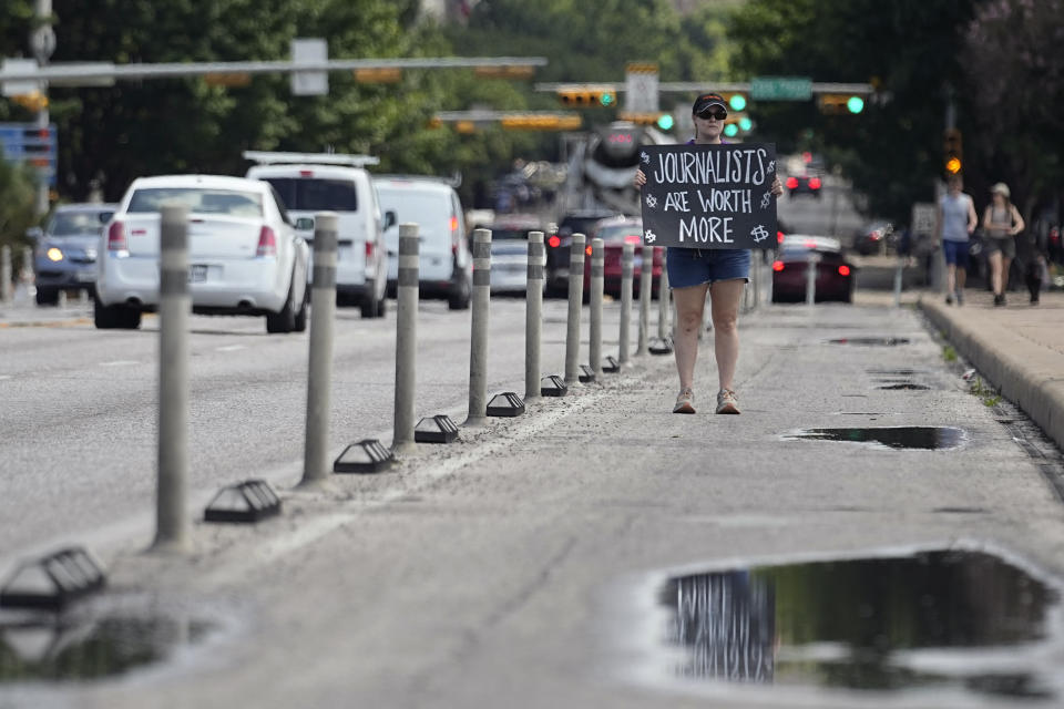 A person pickets on behalf of the Austin American-Statesman's Austin NewsGuild in Austin, Texas, Monday, June 5, 2023. The mostly one-day strike aims to protest the company's leadership and cost-cutting measures imposed since its 2019 merger with GateHouse Media. (AP Photo/Eric Gay)