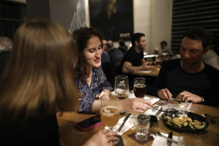 Israeli customers sit at the Libira Brewery pub, which has been attacked by some Jewish hardliners for serving a Palestinian beer launched by a brewery in the occupied West Bank