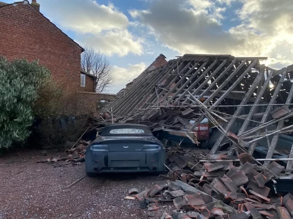 An Aston Martin V8 Vantage worth £30,000 was inside the open-fronted barn when it collapsed (SWNS)