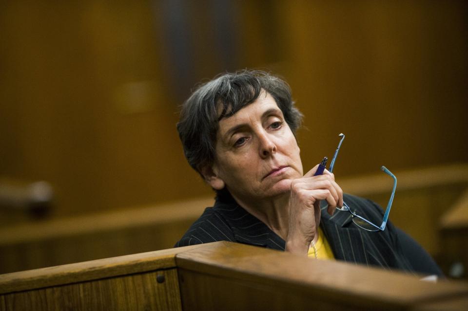 FILE- In a Feb. 5, 2018, file photo, defendant Liane Shekter-Smith, 57, listens during a preliminary examination in the cases of four defendants, all former or current officials from the Michigan Department of Environmental Quality in Flint, Mich. Shekter-Smith, Michael Prysby and Stephen Busch of the MDEQ recently accepted plea deals in the Flint water criminal investigation. Some Flint residents are upset, saying key people who could have stopped the lead disaster in 2014-15 are getting off easy. (Jake May/The Flint Journal via AP, File)