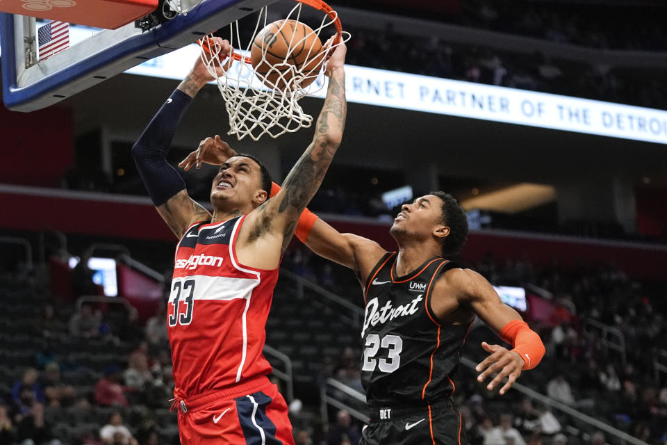 Washington Wizards forward Kyle Kuzma (33) dunks on Detroit Pistons guard Jaden Ivey (23) in the second half of an NBA basketball game in Detroit, Saturday, Jan. 27, 2024. (AP Photo/Paul Sancya)