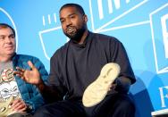 Kanye West speaks on stage with Yeezy head designer Steven Smith during a conversation with Mark Wilson at the <em>Fast Company</em> Innovation Festival on Thursday in N.Y.C.