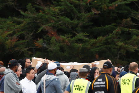 Relatives and other people arrive to attend the burial ceremony of Tariq Rashid Omar, a victim of the mosque attacks, at the Memorial Park Cemetery in Christchurch, New Zealand March 21, 2019. REUTERS/Edgar Su