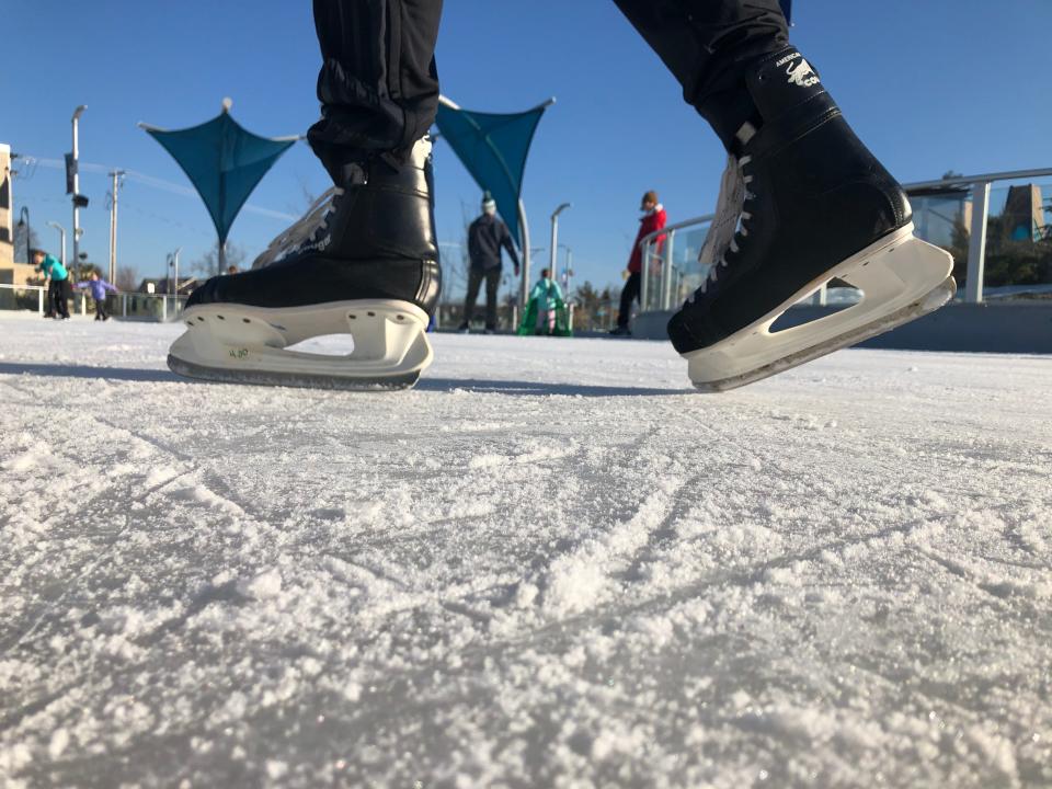 Skaters carve the ice at South Bend's Howard Park ice trail and pond Sunday, Feb. 27, 2022.