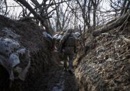 A Ukrainian service member is seen in a trench at a position outside the frontline town of Horlivka