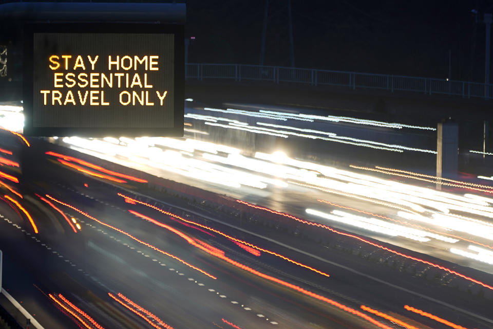 KNUTSFORD, ENGLAND - NOVEMBER 11: (EDITORS NOTE: Image was created using a long exposure) In this long exposure photograph, an electronic matrix sign informs motorists on the M6 in Cheshire 'Stay Home Essential Travel Only' on November 11, 2020 in Knutsford, United Kingdom. England enters the second national coronavirus lockdown today. People are still permitted to exercise with one other person, takeaway food is permitted but bars and restaurants are shut for sit-in service. Schools will remain open but people are being advised to work from home where possible and only undertake necessary travel. All non-essential shops are closed with supermarkets and builders' merchants remaining open. (Photo by Christopher Furlong/Getty Images)