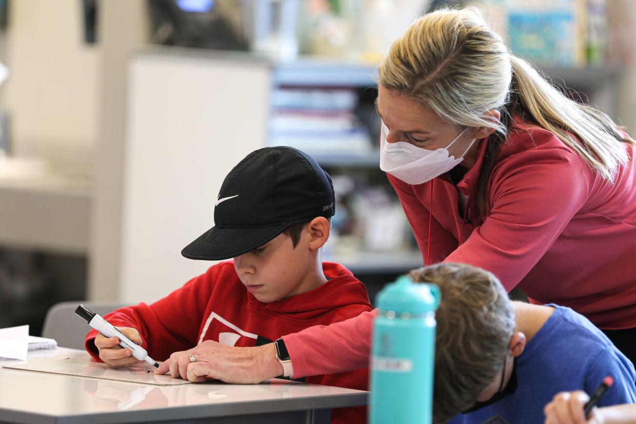 Bear Creek Elementary School fourth grade teacher Jewellyn Forrest works with a student in March 2022. Data from STAAR tests show older students are rebounding from the effects of the pandemic on learning. Younger students' results will be released Aug. 16.