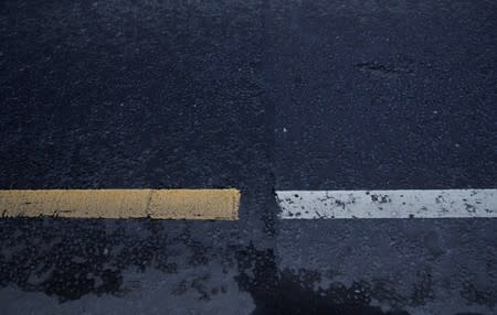 Different coloured road markings and a line in the tarmac mark the border between Ireland and Northern Ireland in Bridgend Northern Ireland