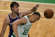 The ball gets away from Boston Celtics forward Grant Williams (12) and Phoenix Suns forward Dario Saric, left, in the first half of an NBA basketball game, Thursday, April 22, 2021, in Boston. (AP Photo/Elise Amendola)