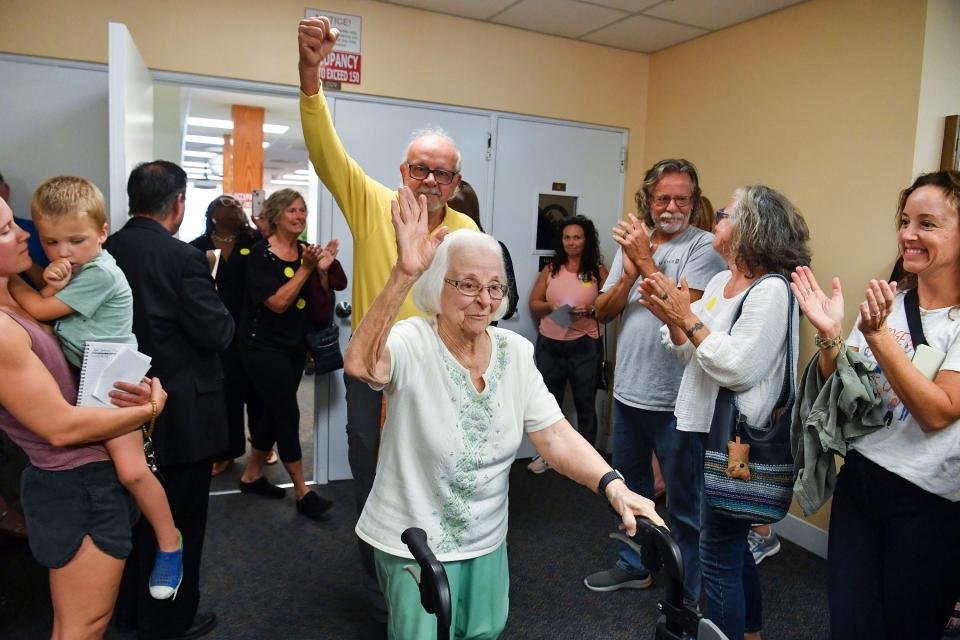 Grace Linn, 100, of Jensen Beach, waves to an applauding crowd after she spoke about the 80 books that were removed last month from district school media centers, during the Martin County School Board meeting, Tuesday, March 21, 2023, at 500 SE Ocean Blvd in Stuart. "My husband, Robert Nicoll, was killed in action in World War II, at a young age, defending our democracy, Constitution and freedoms," said Linn. "One of the freedoms the Nazis crushed was the freedom to read the books they banned. They stopped the free press, banned and burned books. The freedom to read, which is protected by the First Amendment is our essential right and duty of our democracy. Even so, it is continually under attack by both public and private groups who think they hold the truth." Pulitzer Prize winner Toni Morrison and best-selling young-adult novelist Jodi Picoult are some of the writers whose works were removed from the Martin County School District's middle and high schools last month.