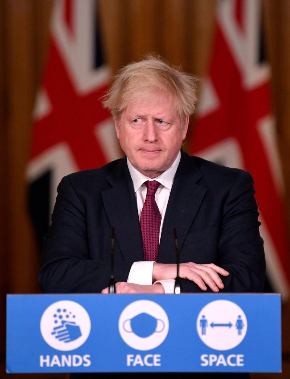 Boris Johnson at his lecturn where he announced stricter Covid rules in December 2020 (PA)