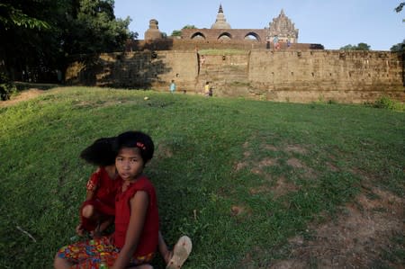 Recently displaced children play around the ancient pagodas in Mrauk U,