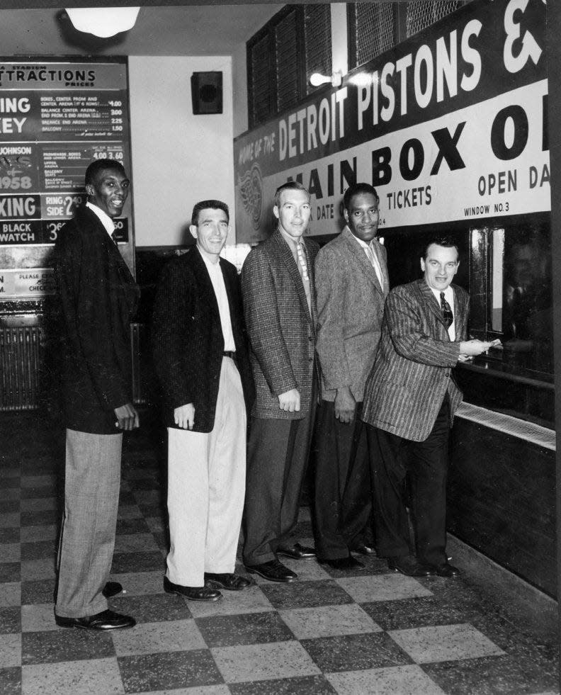 This shot was taken in 1957 at the new Detroit Pistons box office located inside Olympia stadium. From left to right are Piston players Walter Dukes, Gene Shue, Harry Gallatin, Nat (Sweetwater) Clifton and coach Charley Eckman.