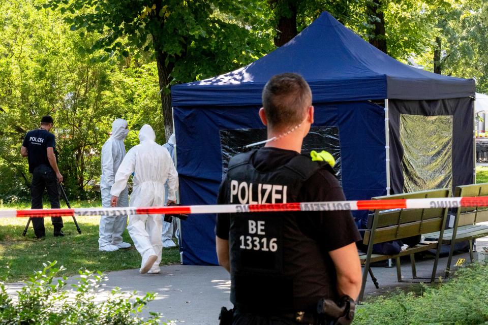 This photo taken on August 23, 2019 shows forensic experts of the police securing evidences at the site of a crime scene in a park of Berlin's Moabit district, where a man of Georgian origin was shot dead. - Russia said Thursday, December 12, 2019 it was expelling two German diplomats, in a tit-for-tat move after Berlin ejected two Russians over the killing of a former Chechen commander in a Berlin park. (Photo by Christoph Soeder / dpa / AFP) / Germany OUT (Photo by CHRISTOPH SOEDER/dpa/AFP via Getty Images)