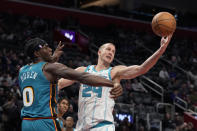 Charlotte Hornets center Mason Plumlee (24) reaches for the rebound next to Detroit Pistons center Jalen Duren (0) during the second half of an NBA basketball game, Friday, Feb. 3, 2023, in Detroit. (AP Photo/Carlos Osorio)