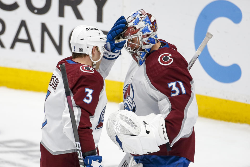 Colorado Avalanche defenseman Jack Johnson (3) greets with goalie Jonas Johansson (31) after the team defeated the Anaheim Ducks during the third period of an NHL hockey game in Anaheim, Calif., Monday, March 27, 2023. (AP Photo/Ringo H.W. Chiu)