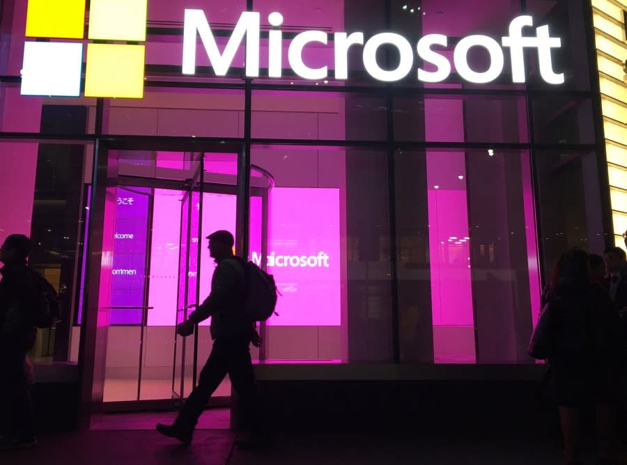 FILE – In this Nov. 10, 2016, file photo, people walk past a Microsoft office in New York. Microsoft says it is making a “multiyear, multibillion dollar investment” in the artificial intelligence startup OpenAI, maker of ChatGPT and other tools that can generate readable text, images and computer code. (AP Photo/Swayne B. Hall, File)