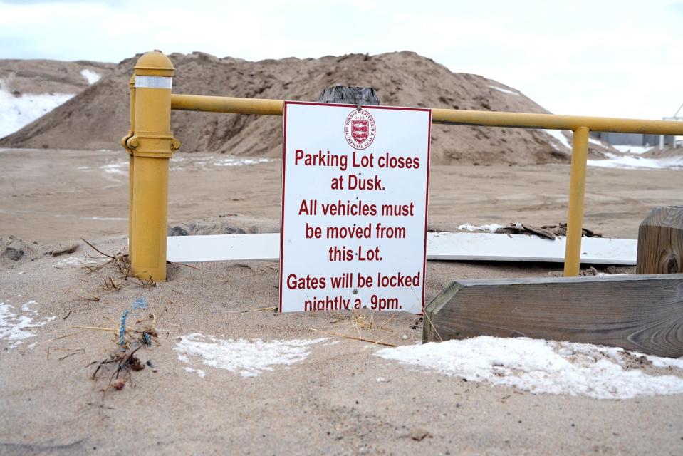 The Westerly Town Beach parking lot entrance sign is shrouded in sand from the most recent storm.