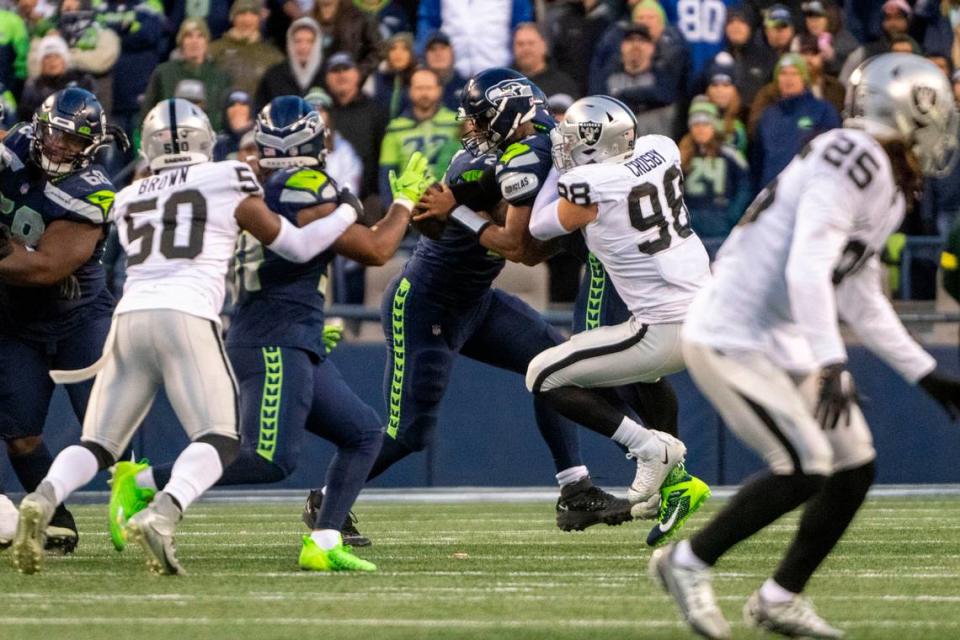 Las Vegas Raiders defensive end Maxx Crosby (98) sacks Seattle Seahawks quarterback Geno Smith (7) during the fourth quarter of an NFL game on Sunday, Nov. 27, 2022, at Lumen Field in Seattle.