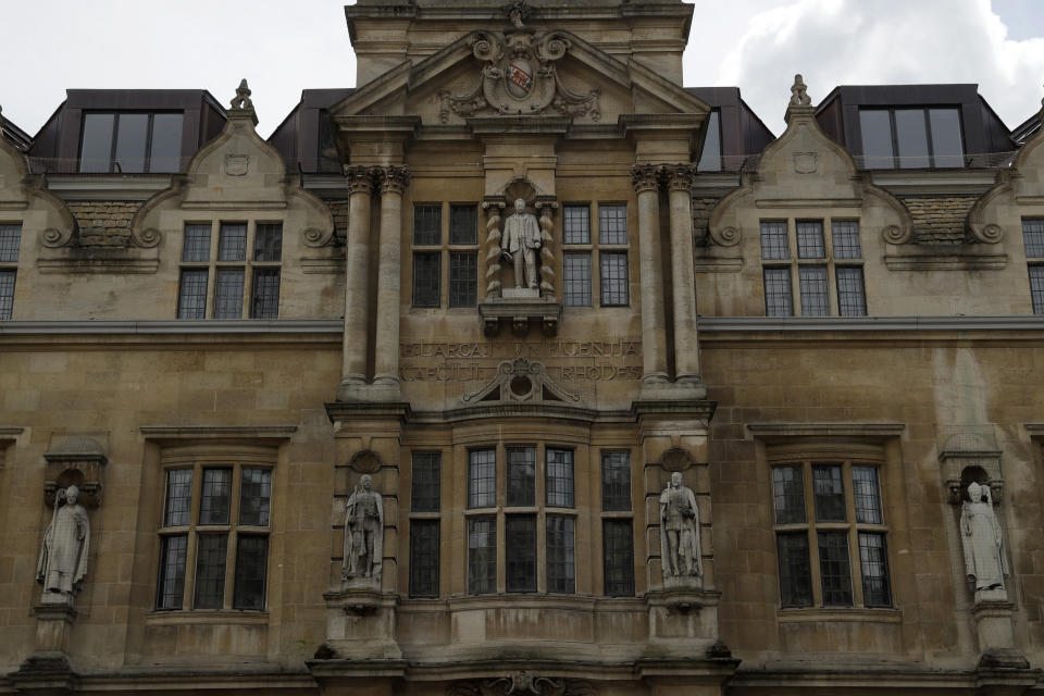 A statue of Cecil Rhodes, top centre, the controversial Victorian imperialist who supported apartheid-style measures in southern Africa stands mounted on the facade of Oriel College in Oxford, England, Wednesday, June 17, 2020. The governing body of Oriel College are meeting today to discuss the future of the statue. (AP Photo/Matt Dunham)