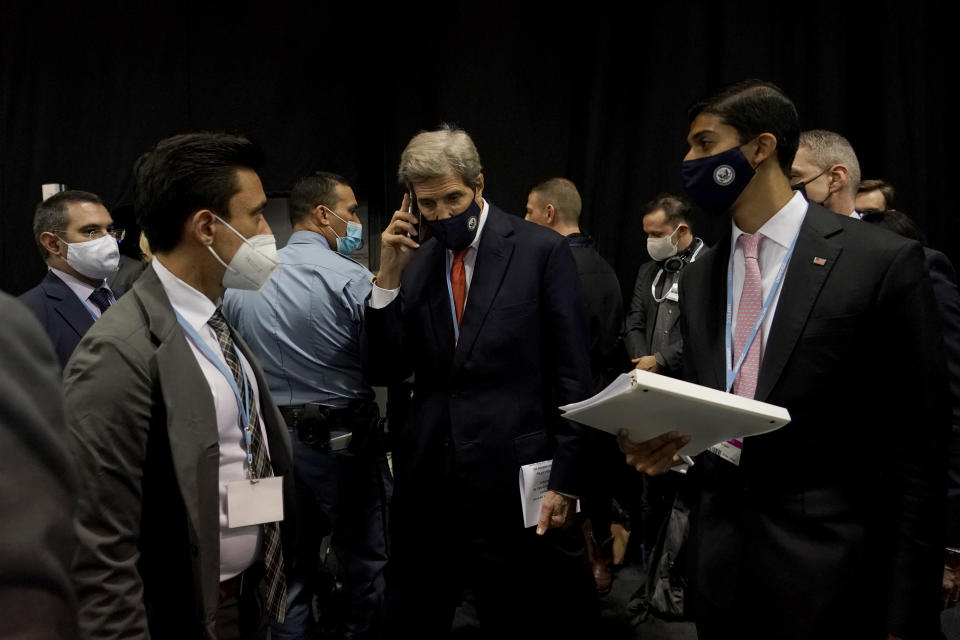 John Kerry, center, United States Special Presidential Envoy for Climate, arrives to speak at a Clean Energy Demand Initiative (CEDI) launch event in the U.S. Pavilion at the COP26 U.N. Climate Summit, in Glasgow, Scotland, Thursday, Nov. 4, 2021. The U.N. climate summit in Glasgow gathers leaders from around the world, in Scotland's biggest city, to lay out their vision for addressing the common challenge of global warming. (AP Photo/Alberto Pezzali)
