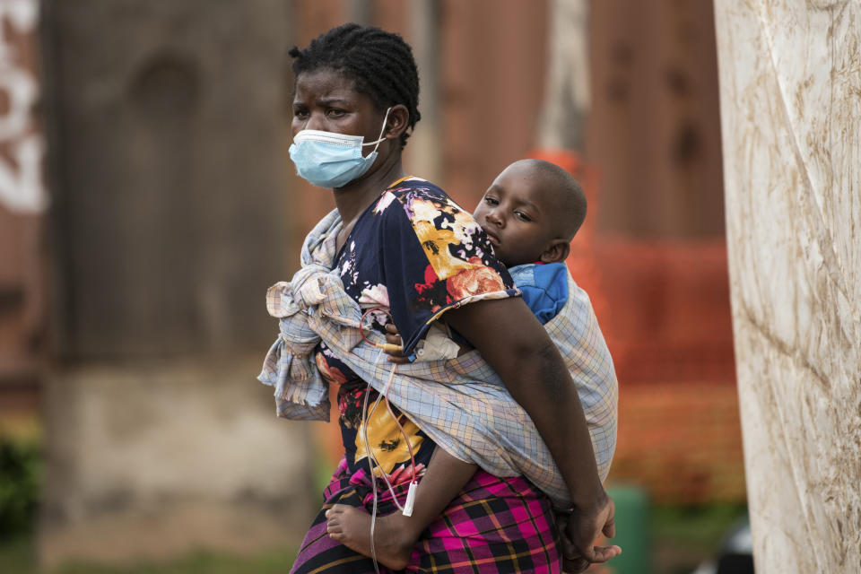FILE - A woman carries her son, who has cholera, at Bwaila Hospital in Lilongwe central Malawi, on Jan. 11, 2023. Malawi’s cholera outbreak has now claimed more than 1,000 lives by Tuesday, Jan. 25, 2023 according to the country’s health minister, who warned that some cultural beliefs and hostility towards health workers are slowing down response efforts. (AP Photo/Thoko Chikondi, File)