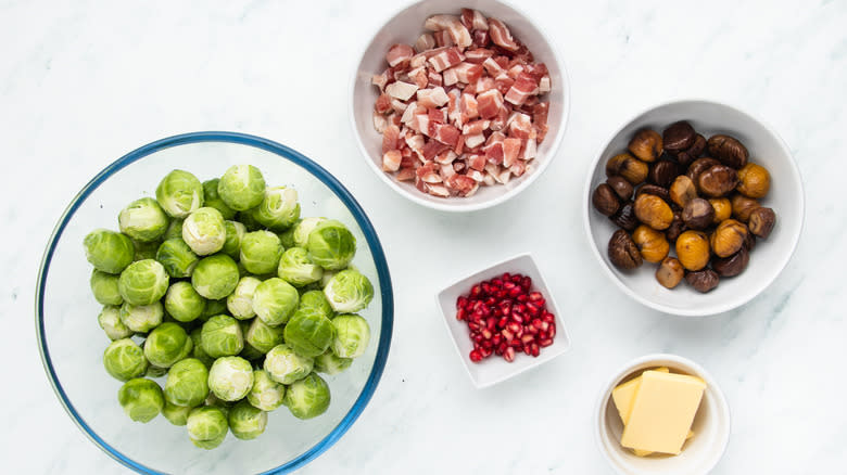 Brussels sprouts with chestnuts and bacon ingredients in bowls